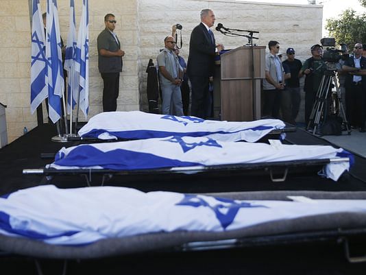 Israeli Prime Minister Benjamin Netanyahu eulogizes three Israeli teens who were abducted and killed in the West Bank during their joint funeral in the Israeli city of Modiin, July 1. Photo: AP