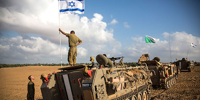An Israeli soldier stands on top of an armored personnel carrier near the Israeli-Gaza border on July 15, 2014 near Sderot, Israel. Photo: Getty Images