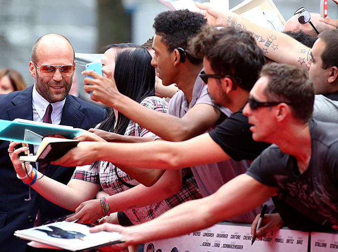 Cast member Jason Statham meets fans as he arrives for the world premiere of the film 