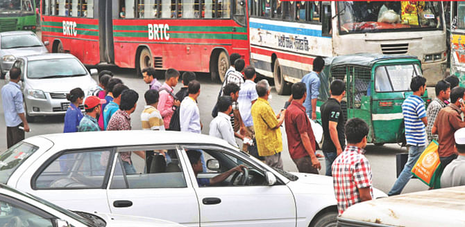 This July 9 Star photo shows pedestrians crossing a road randomly. The photo has been taken from near the intersection at Hazrat Shahjalal International Airport in Dhaka.