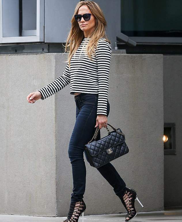 The 44-year-old superstar looked well put together in skinny jeans, a black and white top with stripes, sky high heels and a Chanel purse. The photo is taken from Daily Mail Online. 