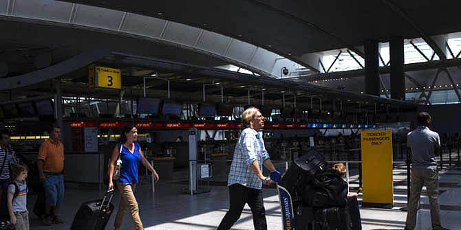 People walk in the Delta Airlines terminal at John F Kennedy Airport in New York City last year. The Federal Aviation Administration (FAA) has halted all flights from the U.S. to Tel Aviv, Israel following a rocket attack near Ben Gurion International Airport. Photo: AFP
