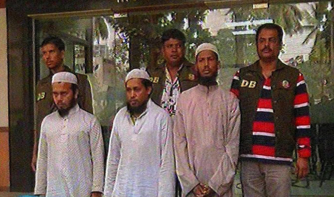 Detectives produce three JMB men, arrested Sunday night, before newsmen at Dhaka Metropolitan Police media centre in the capital. Photo: TV grab