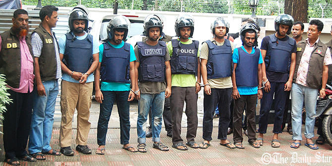 Detectives produce the seven activists of banned militant outfit Jama'atul Mujahideen Bangladesh (JMB) including its acting ameer before the media today after arresting them in Turag area on the outskirt of Dhaka yesterday afternoon. Photo: Rashed Shumon