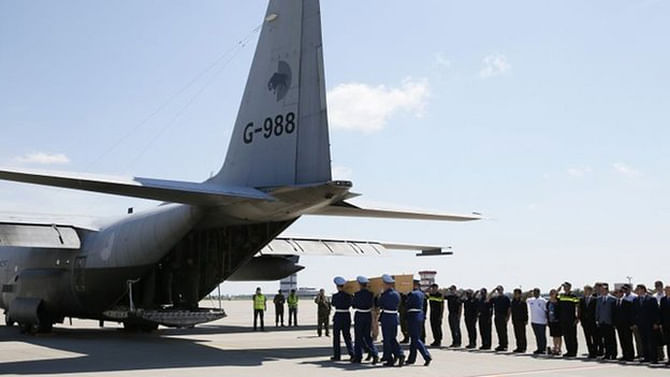 Honour guards carried the coffins on to two planes at Kharkiv airport. Photo taken from BBC