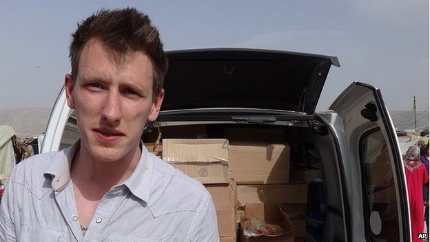 An undated photo provided by Kassig family shows Abdul-Rahman Kassig standing in front of a truck filled with supplies for Syrian refugees. Abdul-Rahman Kassig was working for the relief organisation Sera when he was captured, his parents said