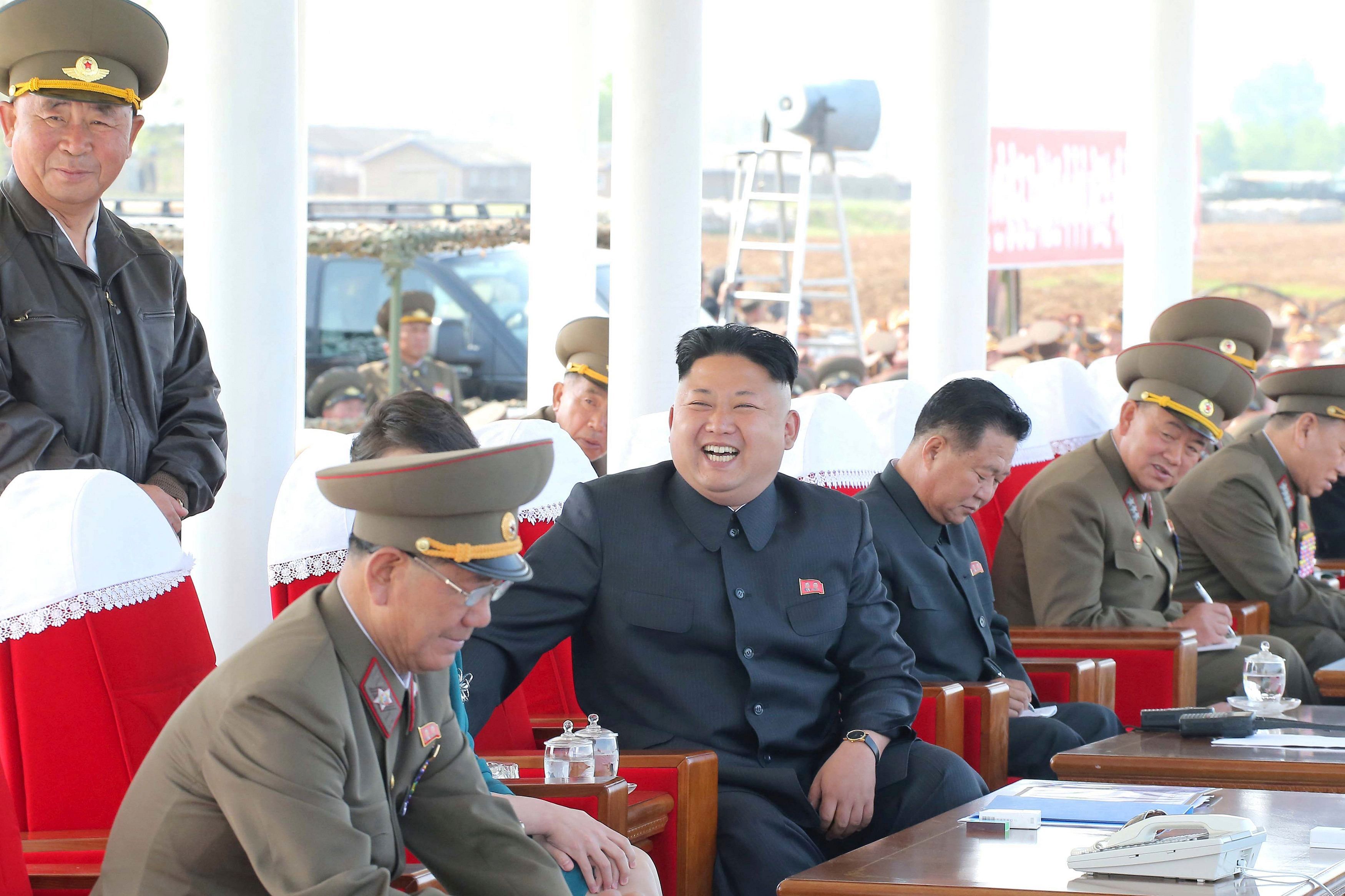 Vice Marshall Hwang Pyong So (bottom L), in full Korean People’s Army uniform, watches an air show by the Korean People’s Air Force with North Korean leader Kim Jong Un (C) on May 10, 2014 in this photo released by North Korea's Korean Central News Agency (KCNA). Photo: Reuters 