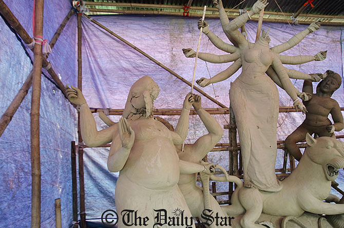 Miscreants desecrate idols of Hindu god and goddess at a puja mandap in Batrish area of Kishoreganj town early Thursday. Photo: Star