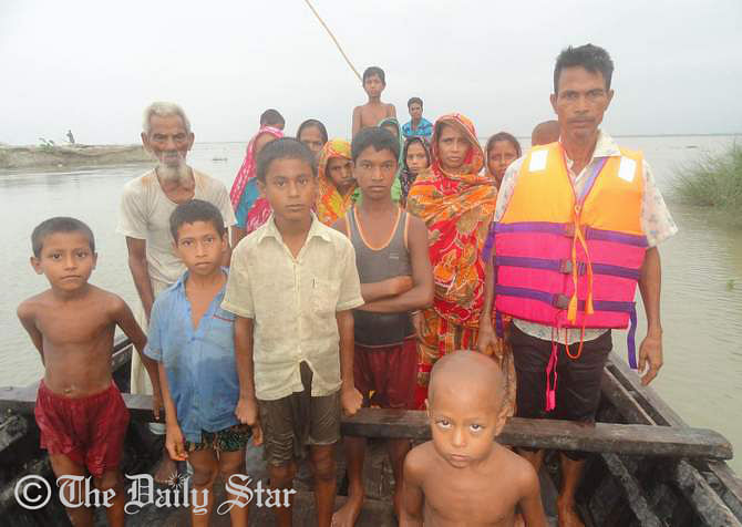 Flood-hit people are being shifted to safe place from Narsing Char village in Aditmari upazila of Lalmonirhat after their village goes under water of Teesta due to heavy rainfall and upstream. Photo: STAR
