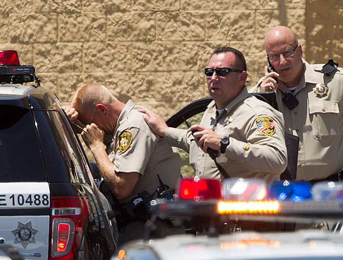 Metro Police officers are shown outside a Wal-Mart after a shooting in Las Vegas on June 8, 2014. Las Vegas police said on Sunday that a shooting incident involving officers resulted in injuries and urged people to stay away from the scene. Photo: Reuters
