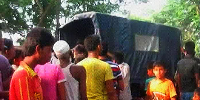 Local people gather at Basurhat in Laxmipur Sadar upazila on Saturday where the bullet-hit body of a Jubo Dal leader was found. Photo: TV grab 