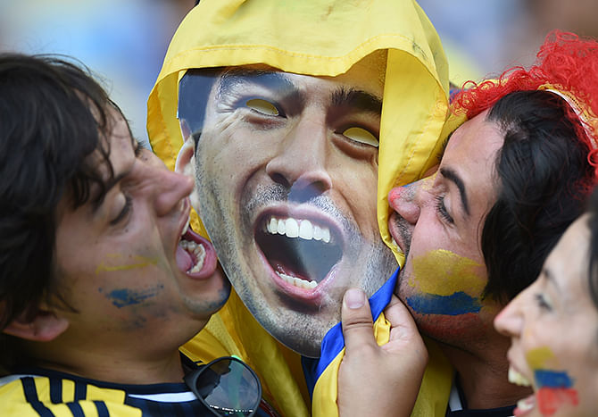 Fans cheer kiss a cardboard cut outs of Uruguayan forward Luis Suarez prior to the Round of 16 football match between Colombia and Uruguay at the Maracana Stadium in Rio de Janeiro during the 2014 FIFA World Cup in Brazil on June 28. Photo: Getty Images 