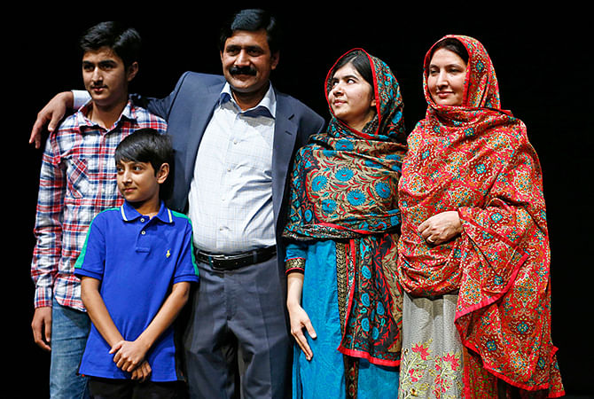 Pakistani schoolgirl Malala Yousafzai (2nd R), the joint winner of the Nobel Peace Prize, stands with her father Ziauddin (C), mother Torpekai (R), and brothers Atal (2nd L) and Khushal, after speaking at Birmingham library in Birmingham, central England October 10, 2014. Photo: Reuters