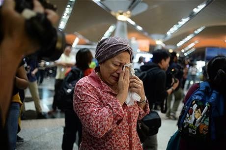 A woman reacts to news regarding a Malaysia Airlines plane that crashed in eastern Ukraine at Kuala Lumpur International Airport in Sepang, Malaysia, Friday. Photo: AP 