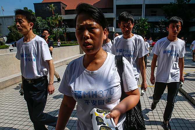 Chinese relatives of passengers onboard the missing Malaysia Airlines Flight MH370 make their way to a meeting at the Holiday Villa in Subangjaya on Sunday. Ten ships and as many aircraft will search a swathe of the Indian Ocean west of Perth on Sunday, trying again to find some trace of missing Malaysia Airlines Flight MH370 after more than three weeks of fruitless and frustrating hunting. Photo: Reuters