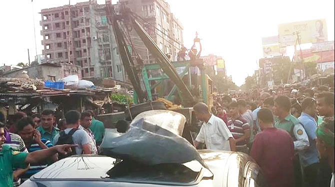 A tracker pulls the damaged car from the spot after it is hit by a train at Malibagh rail crossing in the capital on Friday afternoon. Photo: Courtesy by Rashed Nizam