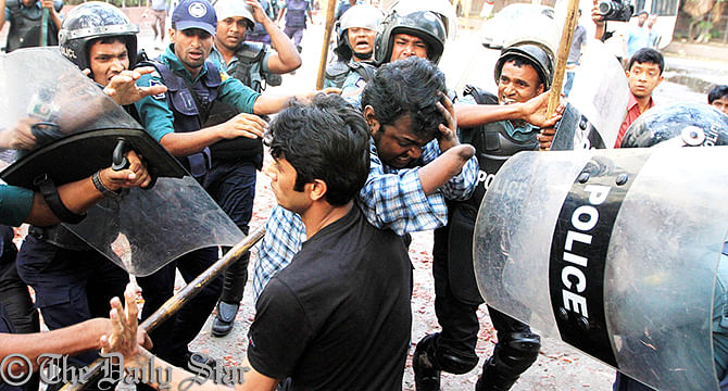 Police detain the activists of Gonojagoron Mancha from Shahbagh in the capital this afternoon. Photo: Palash Khan