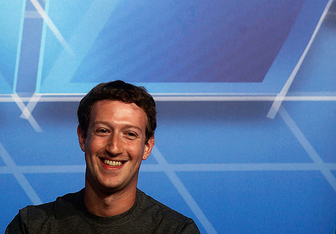 This Reuters photo taken on February 24 shows Facebook Chief Executive Officer Mark Zuckerberg smiling onstage before delivering a keynote speech during the Mobile World Congress in Barcelona.