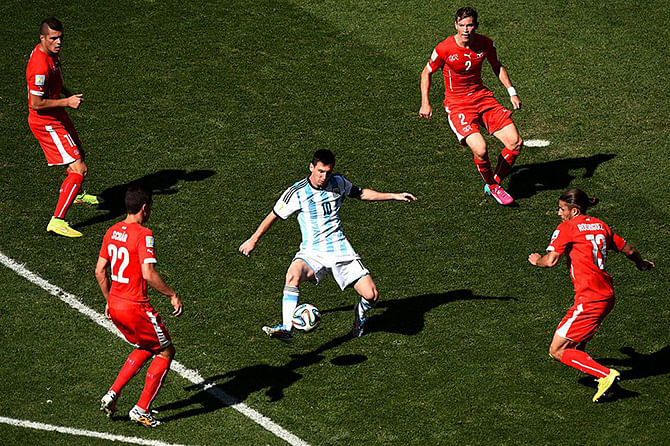 Lionel Messi of Argentina controls the ball against Josip Drmic (L), Fabian Schar (2nd L), Stephan Lichtsteiner (2nd R) and Ricardo Rodriguez of Switzerland during the 2014 FIFA World Cup Brazil Round of 16 match between Argentina and Switzerland. Photo: Getty Images