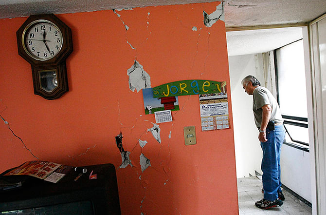 A man inspects the damage in his apartment following an earthquake in Mexico City on Friday. Photo: Reuters