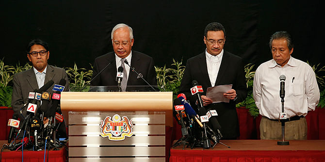 Malaysia's Prime Minister Najib Razak (2nd L) makes an announcement on the latest development on the missing Malaysia Airlines MH370 plane at Putra World Trade Center in Kuala Lumpur on Monday. Photo: Reuters