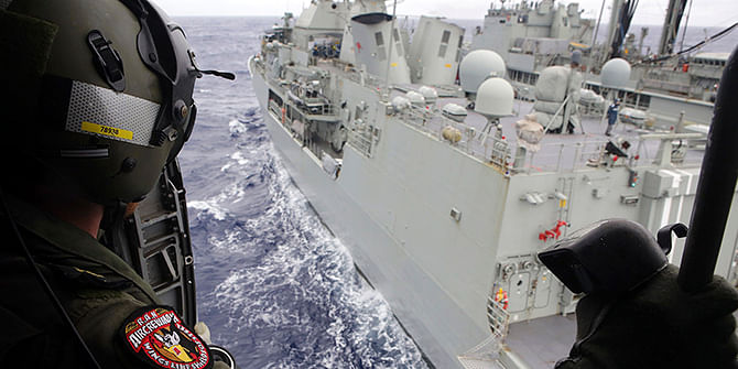 Leading Seaman Aircrewman Joel Young looks out from Tiger75, an S-70B-2 Seahawk helicopter, after it launched from the Australian Navy ship the HMAS Toowoomba as it continues the search in the southern Indian Ocean for the missing Malaysian Airlines flight MH370, in this picture released by the Australian Defence Force on Friday. Photo: Reuters