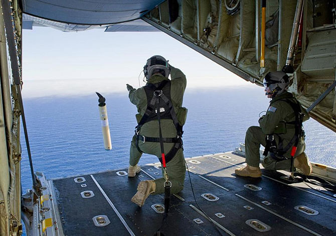 In this March 20, 2014 file photo provided by the Australia Defence Department, Royal Australian Air Force Loadmasters launch a Self Locating Data Marker Buoy from a C-130J Hercules aircraft in the southern Indian Ocean for search of Malaysia plane missing