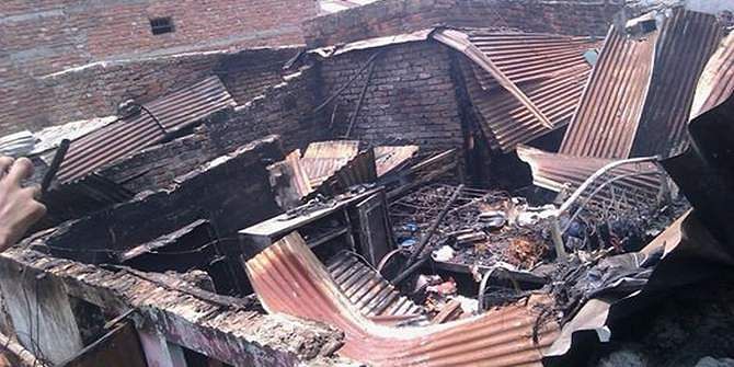 The tin-shed houses are burnt as locals set fire to the houses at Kalsi Bihari camp following a clash Saturday morning. At least 10 people were killed in the incident. Photo: Shaheen Mollah 