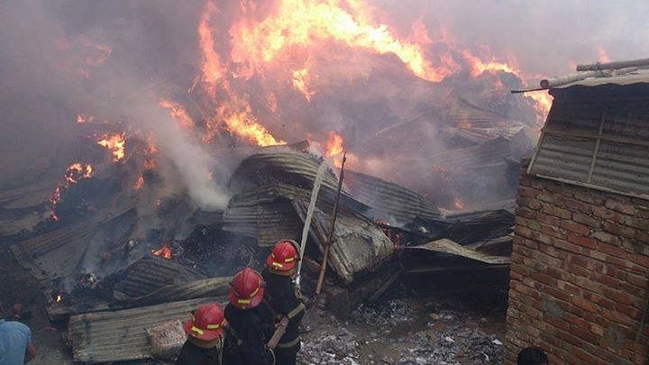 Fire fighters trying to douse the fire that breaks out at jhutpatti in Mirpur of Dhaka Wednesday afternoon. Photo: STAR/ Ridwan Adid Rupon