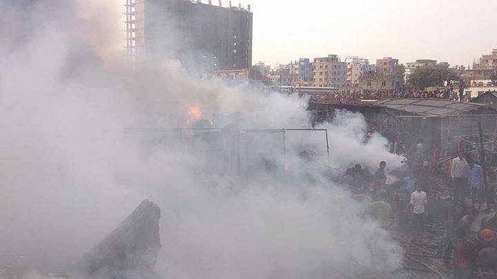 Smoke coming out from the jhutpatti godown at Mirpur in Dhaka Wednesday afternoon. Photo: STAR/ Ridwan Adid Rupon