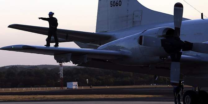 An aircrew walks on the wing of a Japanese Air Force AP-3C Orion after it landed at RAAF Pearce Base before it joins the search for missing Malaysian Airlines flight MH370 in Perth March 23. Photo: Reuters