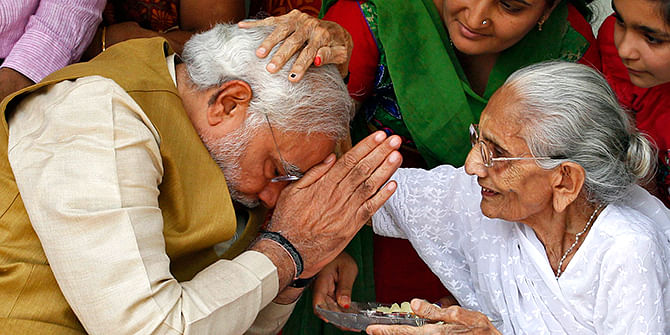 Hindu nationalist Narendra Modi (L), the prime ministerial candidate for India's main opposition Bharatiya Janata Party (BJP), seeks blessings from his mother Heeraben at her residence in Gandhinagar in the western Indian state of Gujarat on Friday. Modi will be the next prime minister of India, with counting trends showing the pro-business Hindu nationalist and his party headed for the most resounding election victory the country has seen in thirty years. Photo: Reuters