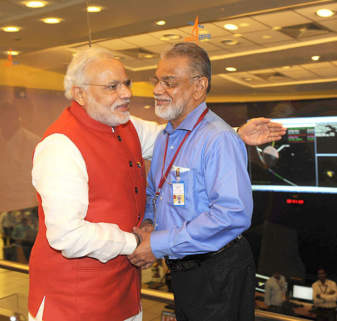 India's Prime Minister Narendra Modi (L) congratulates K Radhakrishnan, head of the state-run Indian Space Research Organisation (ISRO), after India's Mars Obiter successfully entered the red planet's orbit, at their Spacecraft Control Center in the southern Indian city of Bangalore September 24, 2014.  Photo: Reuters