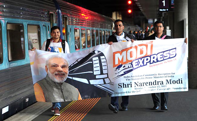 Supporters of Prime Minister Narendra Modi hold a banner as they prepare to ride "Modi Express" from Melbourne to Sydney on November 16. This photo is taken from NDTV website.