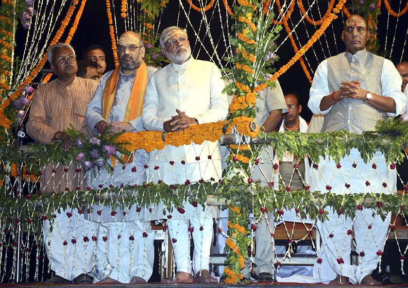 Hindu nationalist Narendra Modi (C), India's prime minister-elect from the Bharatiya Janata Party (BJP), watches a ritual known as "Aarti" during evening prayers on the banks of river Ganges at Varanasi, in the northern Indian state of Uttar Pradesh, May 17, 2014. Photo: Reuters