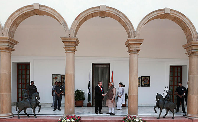 India's Prime Minister Narendra Modi (centre R) shakes hands with his Pakistani counterpart Nawaz Sharif (centre L) before the start of their bilateral meeting in New Delhi on Tuesday. Photo: Reuters