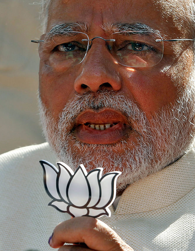 This reuters photo taken on April 30 shows Hindu nationalist Narendra Modi, the prime ministerial candidate for India's main opposition Bharatiya Janata Party (BJP), holds a lotus cut-out after casting his vote at a polling station during the seventh phase of India's general election in the western Indian city of Ahmedabad. 