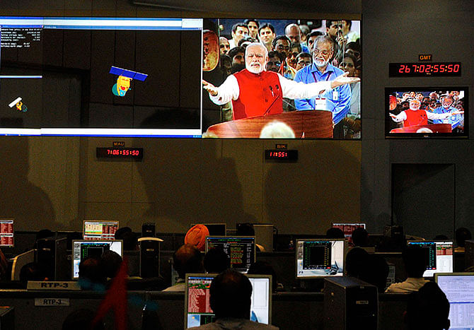 Indian Space Research Organization (ISRO) scientists and engineers watch Prime Minister Narendra Modi (L) on screens after India's Mars orbiter successfully entered at their Spacecraft Control Center in the southern Indian city of Bangalore September 24, 2014. Photo: Reuters