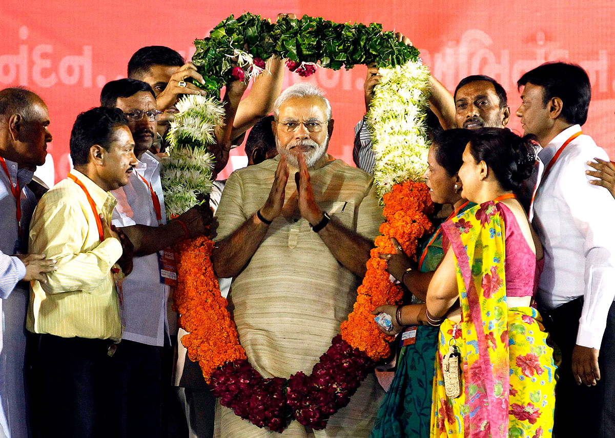 Hindu nationalist Narendra Modi, who will be the next prime minister of India, wears a garland presented to him by his supporters at a public meeting in the western Indian city of Ahmedabad May 20, 2014. Photo: Reuters