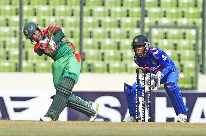 Skipper Mushfiqur drives the ball on his way to half-century at Mirpur stadium before he departs at his 59 off 63 balls in the first match of ODI of three-match series against India on Sunday. Photo: Firoz Ahmed