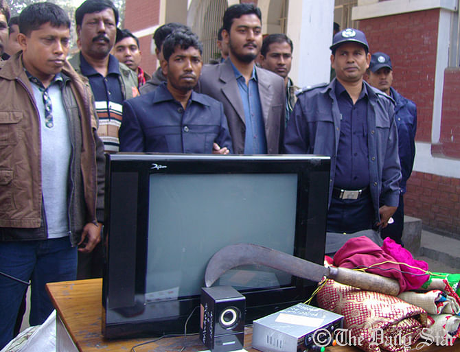 Police on Thursday produce the prime accused of Mymensingh four murder case with the looted things from the victims' house. Photo: STAR