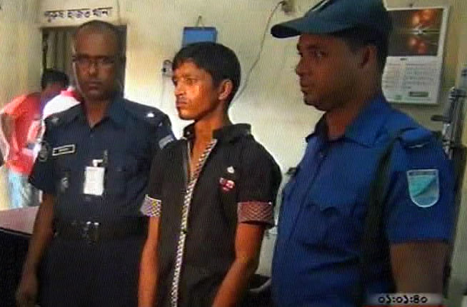 Policemen produce a man who knifed his wife and daughter to death in Narayanganj before reporters on Saturday.  Photo: TV grab