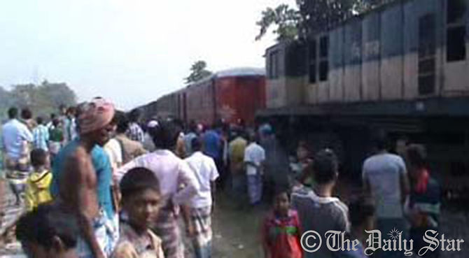 People gather and look at the rescue operation of a derailed train on Thursday at Methikanda Railway Station in Narsinghdi. Photo: STAR