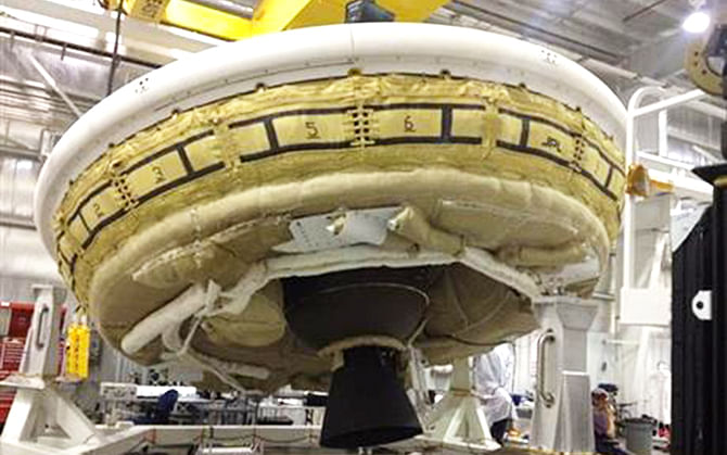 In this undated image provided by NASA a saucer-shaped test vehicle holding equipment for landing large payloads on Mars is shown in the Missile Assembly Building at the US Navy's Pacific Missile Range Facility in Kauai, Hawaii. On Wednesday, June 11, 2014 weather permitting, a balloon carrying the saucer-shaped vehicle is set to launch from Hawaii. Photo: AP/NASA