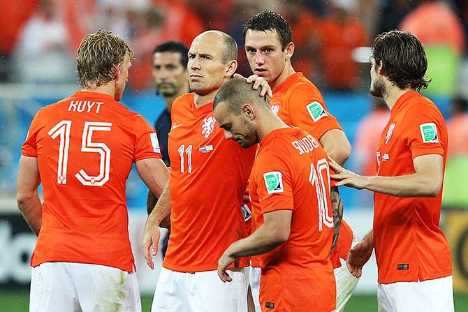 Wesley Sneijder and Arjen Robben of the Netherlands react with teammates after being defeated in a penalty shootout by Argentina during the 2014 FIFA World Cup Brazil Semi Final match between the Netherlands and Argentina at Arena de Sao Paulo on July 9, 2014 in Sao Paulo, Brazil. Photo: Getty Images