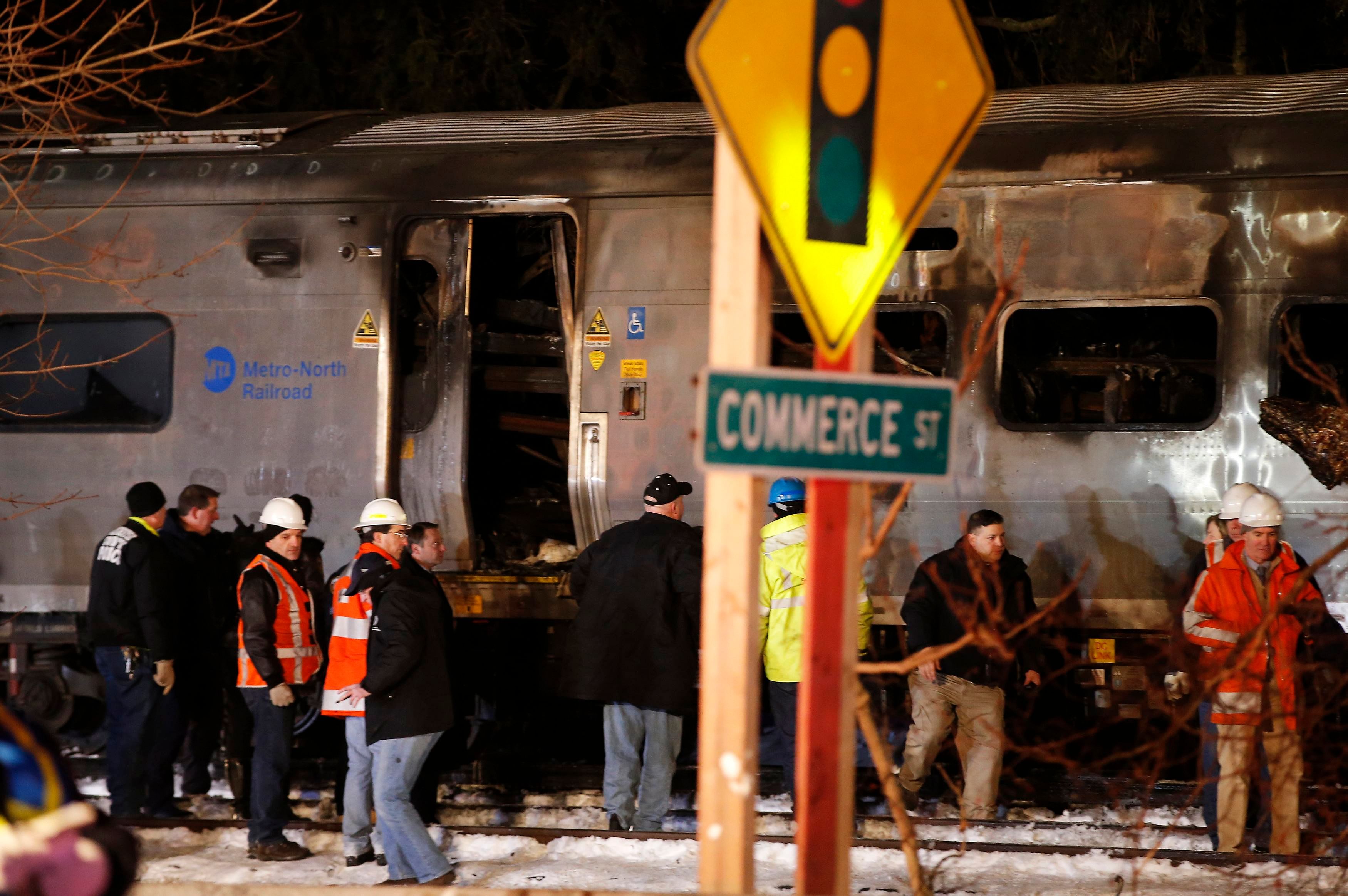 Emergency workers stand near a burned out Metropolitan Transportation Authority (MTA) Metro North Railroad commuter train that hit at least one car near the town of Valhalla, New York, February 3, 2015. Photo: Reuters