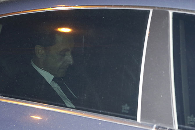 Former French President Nicolas Sarkozy leaves the financial crimes section, on July 2, 2014 in Paris. Nicolas Sarkozy was detained for questioning in a widening corruption probe, a judicial source said, in an unprecedented move against a former French president. Sarkozy had turned himself in for questioning a day after investigators detained his lawyer Thierry Herzog and two magistrates. Photo: Getty Images