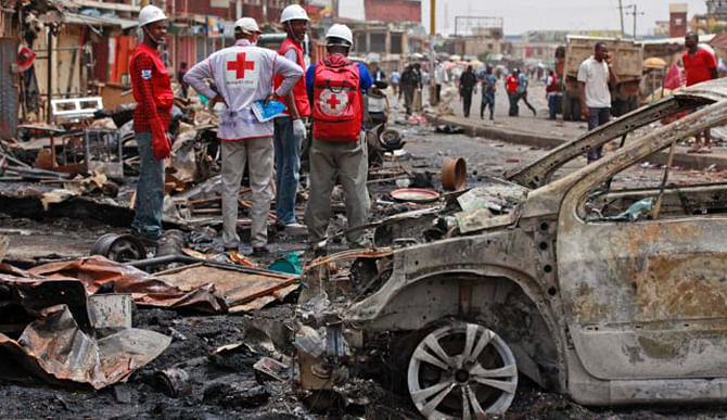 Red Cross personnel search for remains at the site of a Boko Haram car bomb attack in Jos, Nigeria on May 21. Photo: AP
