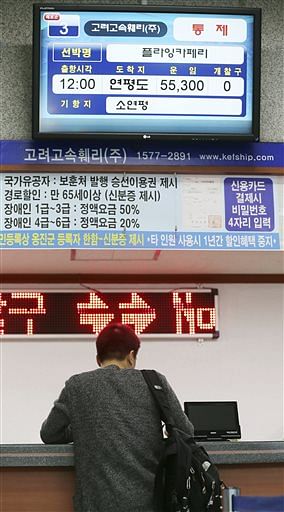 A passenger gets a refund of his ticket for Yeonpyeong island in the western sea at Incheon port passenger terminal in Incheon, west of Seoul, South Korea on Tuesday. Photo: AP