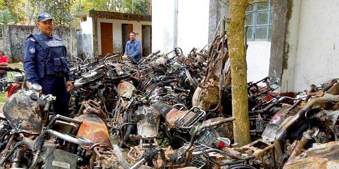 This file photo shows wreckage of 39 burnt motorbikes of the activists of Awami League and its front organisations, bearing testimony to the extent of barbaric attack on a December 14 march led by AL lawmaker Asaduzzaman Noor near Ramganj, eight km off Nilphamari town, is kept on the premises of Nilphamari Sadar Police Station.